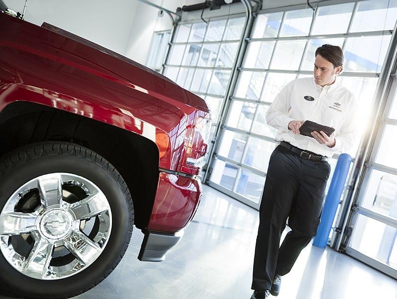 Technician servicing a Chevrolet vehicle