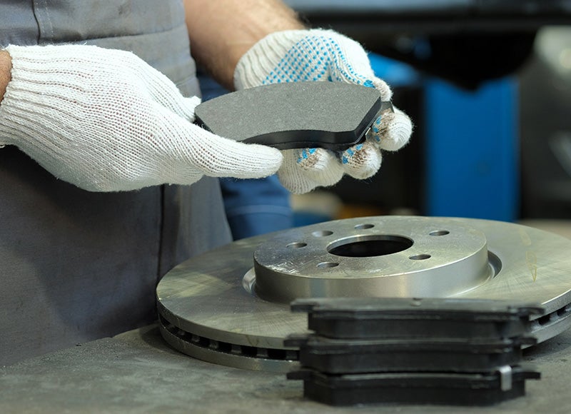 Vehicle brakes and tires being inspected
